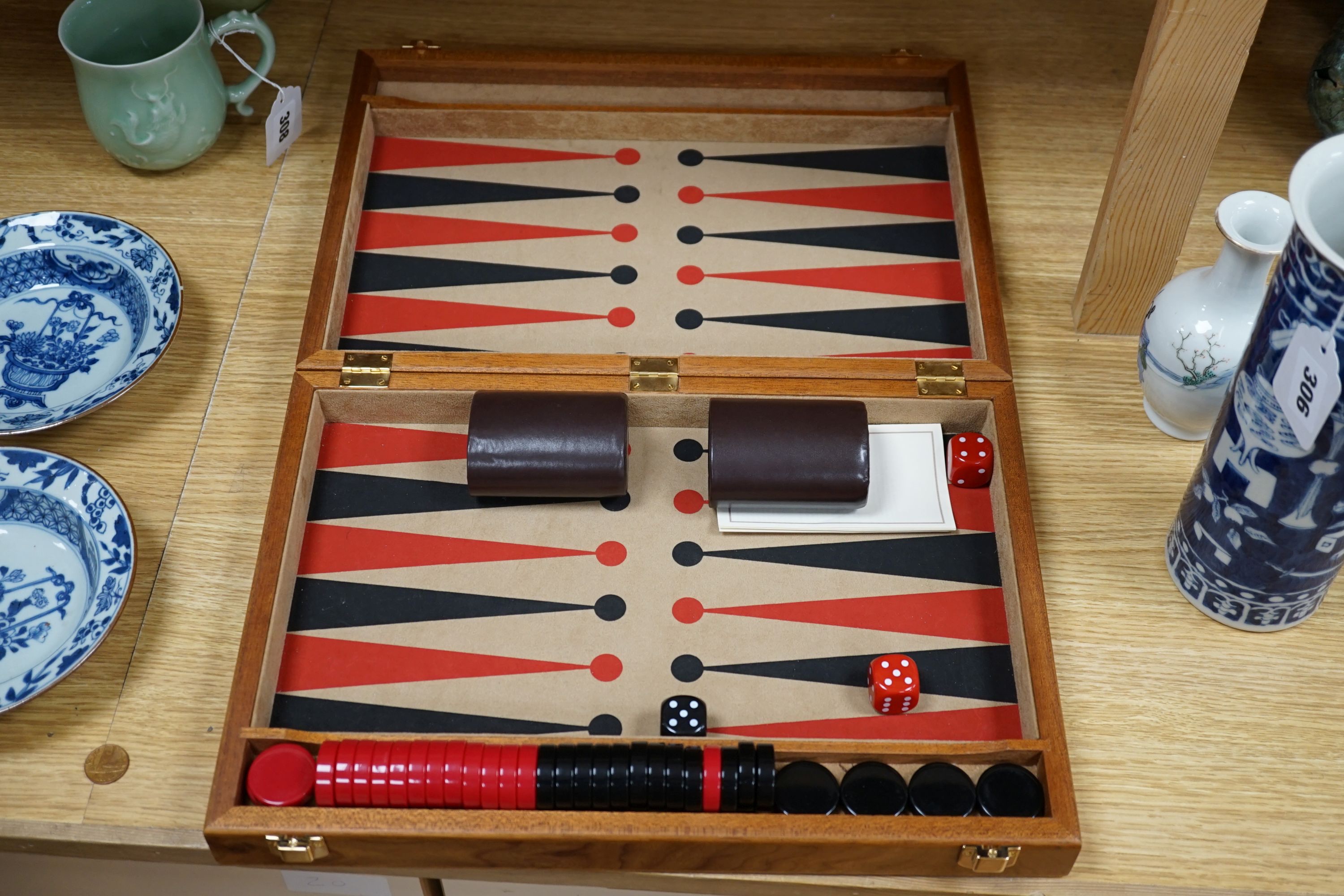 A cased Backgammon set and a chess set with chess-board top and drawers for chess pieces, chess box 35.5 cms x 35.5 cms.